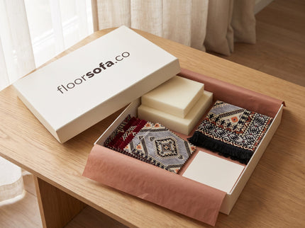 Floorsofa Majlis Sample Box open on a coffee table with fabric swatches and foam samples