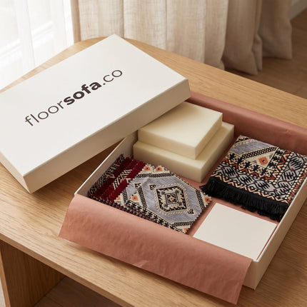 Floorsofa Majlis Sample Box open on a coffee table with fabric swatches and foam samples